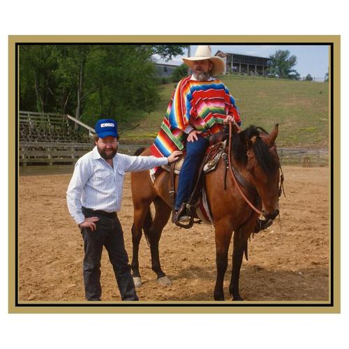 Charlie Daniels sitting on a horse at his ranch in Mount Joliet, TN with Michael W. Rutherford standing next to the horse.