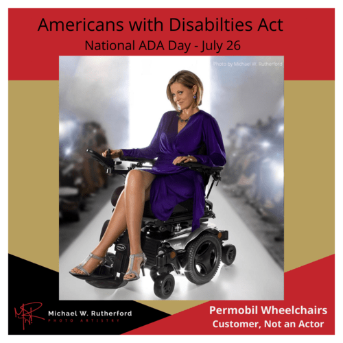 Beautiful woman sitting in a wheelchair on a runway like a fashion show with crowd watching on each side of the runway.