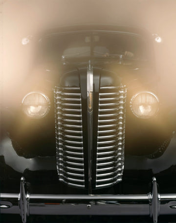 Surreal photograph of a 1940s Buick front grill and headlights by Michael W. Rutherford, showcasing vintage elegance and chrome details in a dreamlike haze.