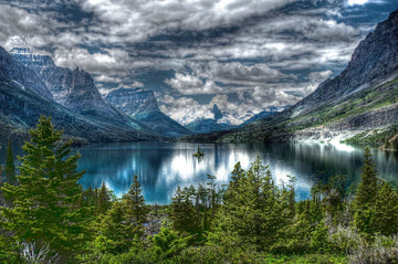 Limited edition print of Glacier Lake, Montana with deep blue lake, snow-capped mountains, and lush green trees by Michael W. Rutherford.