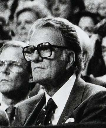 Black and white photograph of Reverend Billy Graham seated at the Republican National Convention, captured by Michael W. Rutherford