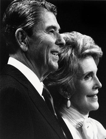 Black and white close-up photograph of Ronald and Nancy Reagan smiling in profile