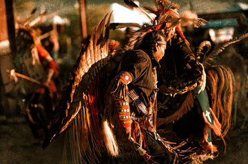 Native American dancer in ornate regalia performing a War Dance, captured by Michael W. Rutherford."