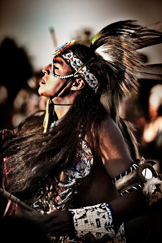 Native American dancer in regalia during a traditional performance, captured by Michael W. Rutherford.